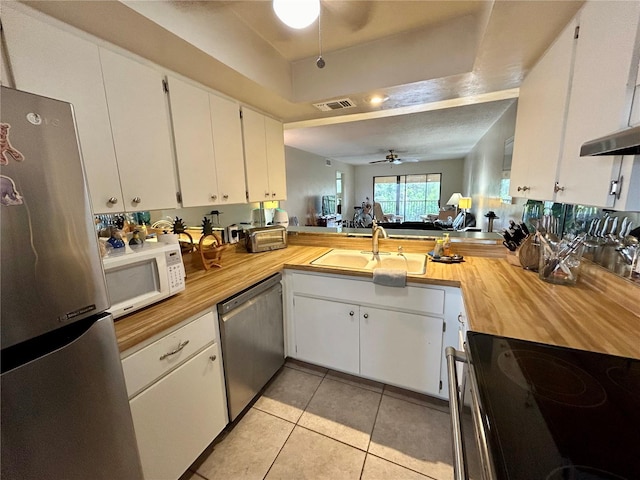 kitchen with ceiling fan, sink, white cabinets, and appliances with stainless steel finishes