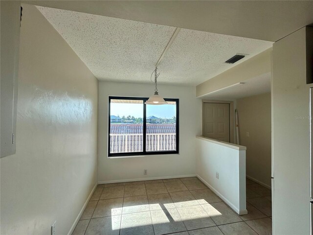 unfurnished dining area with light tile patterned flooring