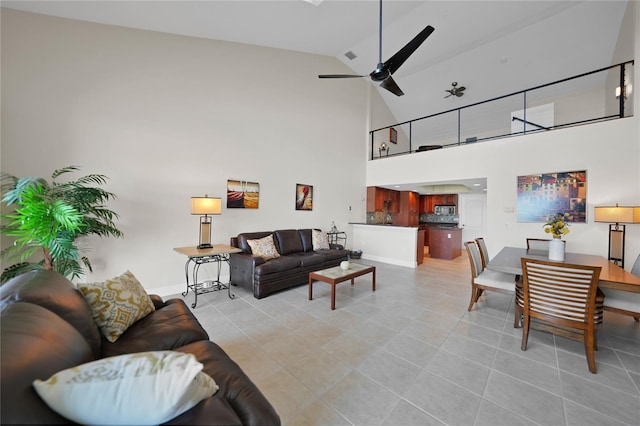 living room featuring high vaulted ceiling, ceiling fan, and light tile floors