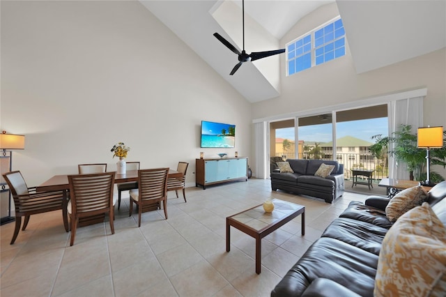 tiled living room with ceiling fan and high vaulted ceiling