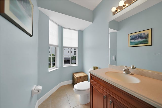 bathroom featuring toilet, large vanity, and tile flooring