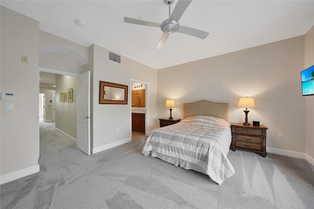 carpeted bedroom featuring ensuite bathroom, ceiling fan, and vaulted ceiling