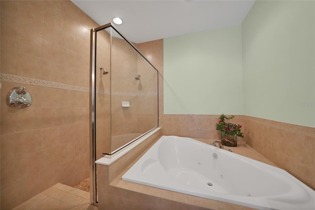 bathroom featuring separate shower and tub