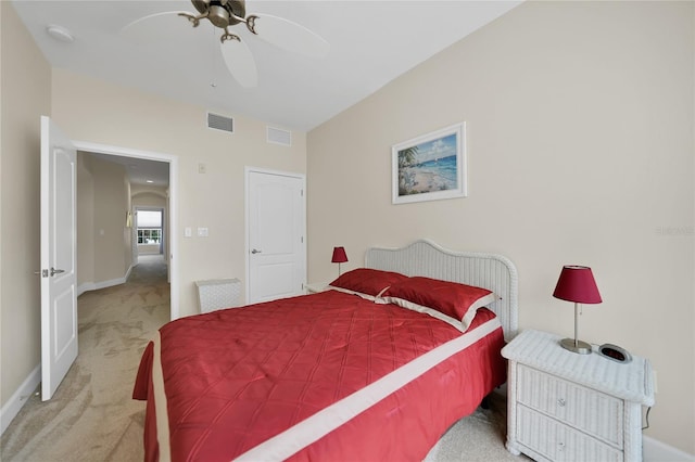 bedroom featuring light colored carpet and ceiling fan