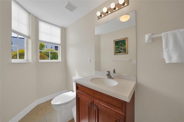 bathroom featuring toilet, tile floors, and vanity