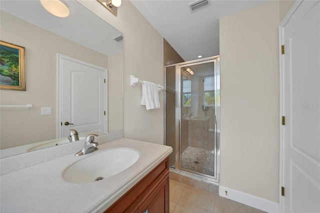 bathroom featuring vanity with extensive cabinet space, tile floors, and a shower with shower door