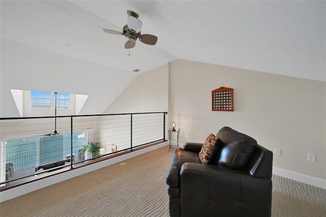 sitting room with vaulted ceiling, ceiling fan, and dark carpet