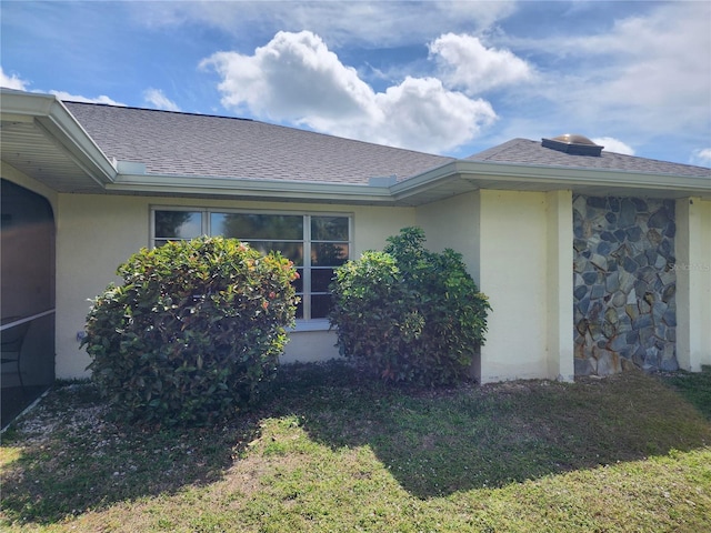 view of side of home featuring a lawn