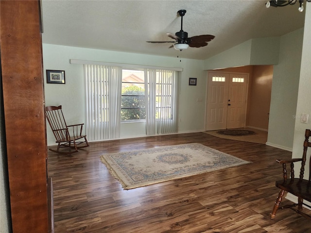 entrance foyer featuring ceiling fan, lofted ceiling, and dark wood-type flooring