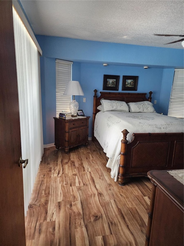 bedroom featuring light hardwood / wood-style flooring and a textured ceiling