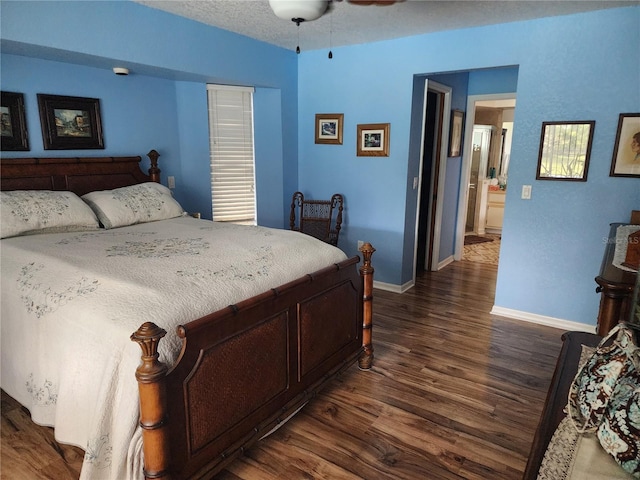 bedroom featuring a textured ceiling, dark hardwood / wood-style floors, and ceiling fan