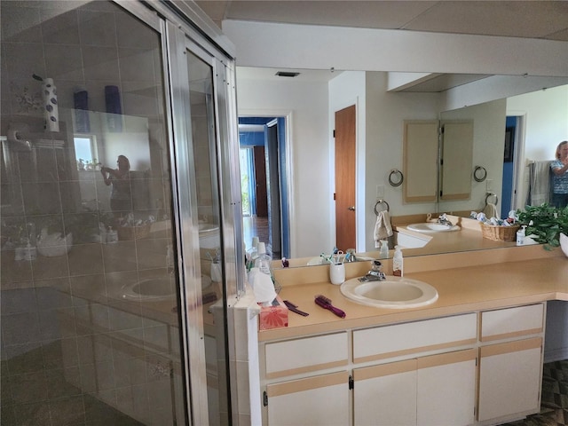 bathroom with large vanity and walk in shower