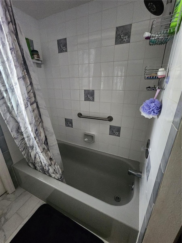 bathroom featuring shower / bathtub combination with curtain