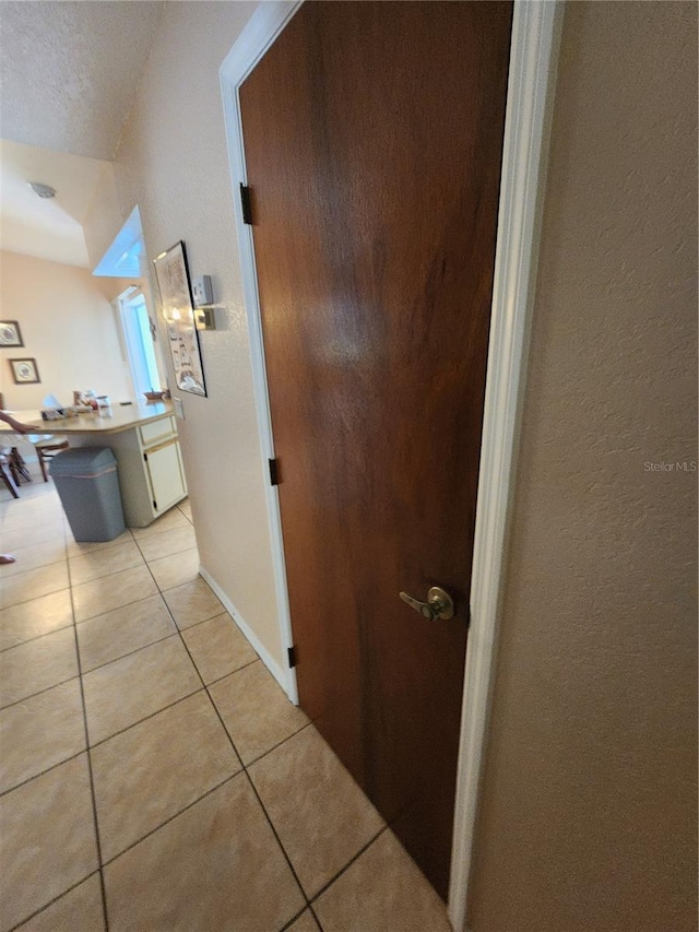 corridor featuring light tile flooring