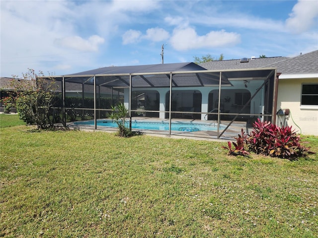 view of swimming pool with a lanai and a yard