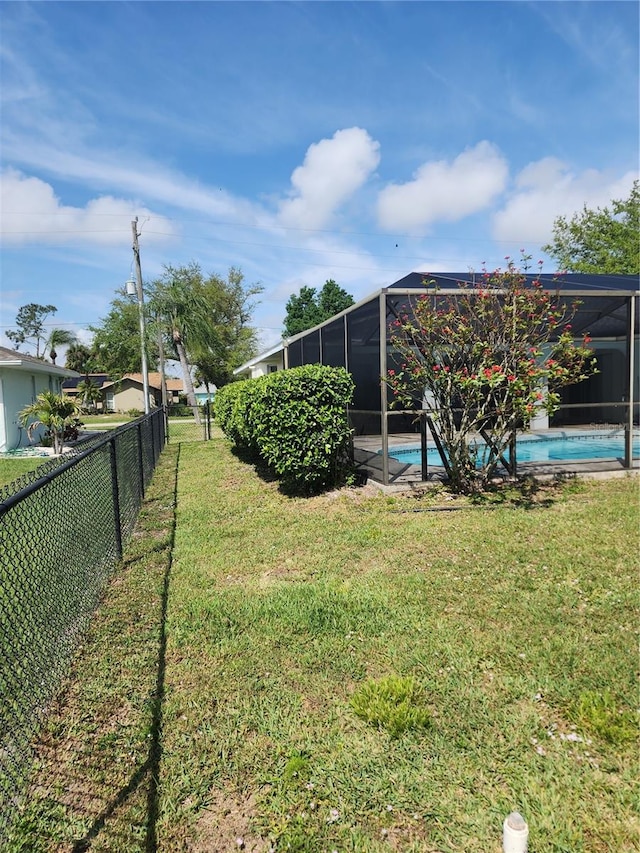 view of yard with a lanai and a fenced in pool