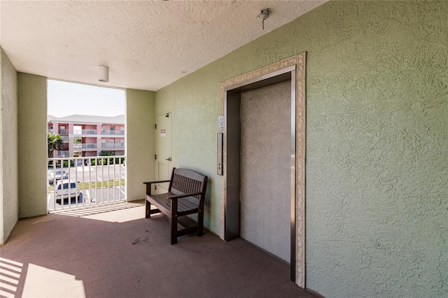 exterior space featuring elevator and a balcony