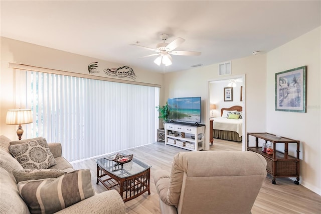 living room featuring ceiling fan and light wood-type flooring