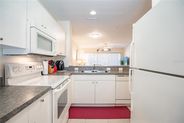 kitchen with white cabinets, white appliances, sink, and light tile flooring