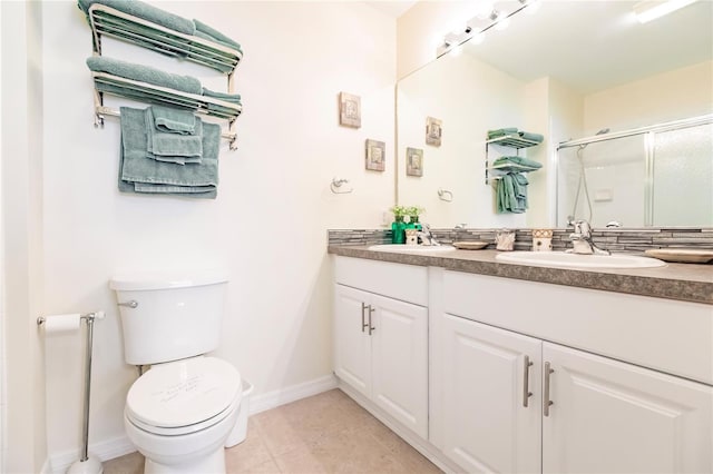 bathroom with vanity with extensive cabinet space, toilet, and tile flooring