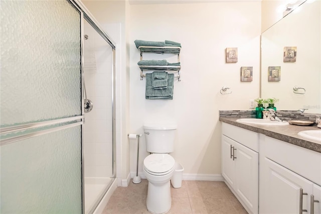 bathroom featuring walk in shower, dual bowl vanity, toilet, and tile flooring