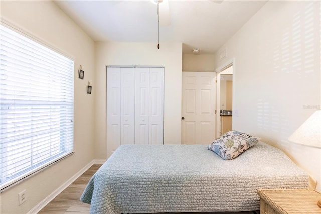 bedroom with a closet, ceiling fan, and hardwood / wood-style floors