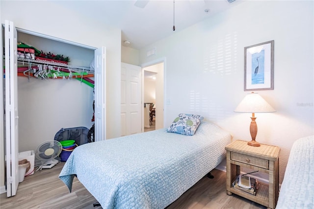 bedroom featuring a closet, ceiling fan, and light wood-type flooring