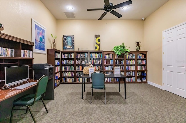 carpeted office space featuring ceiling fan