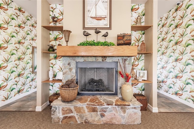 room details featuring dark tile flooring and a stone fireplace