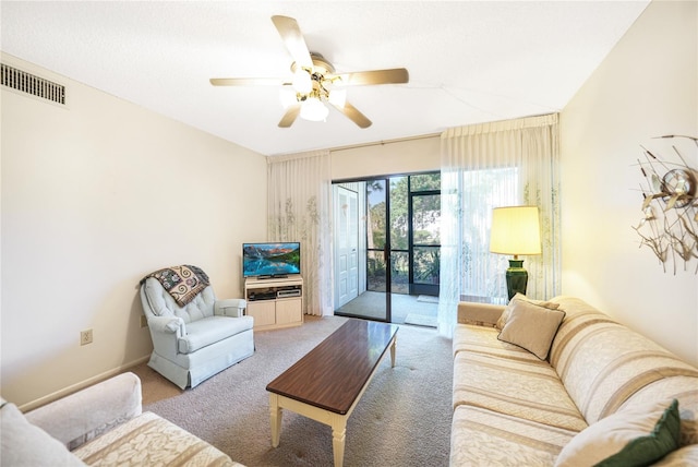 carpeted living room with ceiling fan