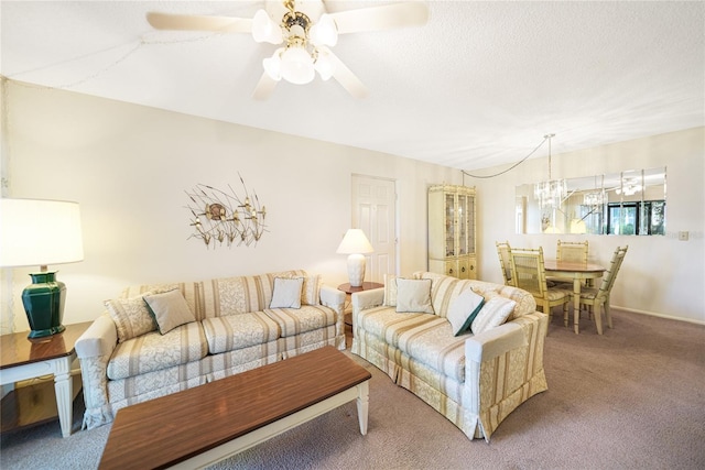 living room featuring ceiling fan with notable chandelier and carpet floors