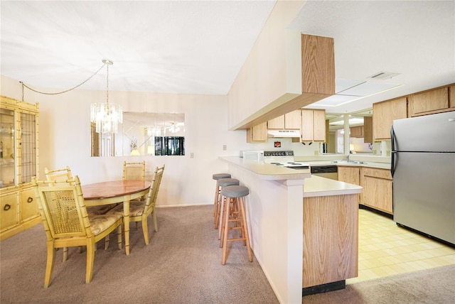 kitchen featuring light colored carpet, hanging light fixtures, a chandelier, and stainless steel appliances