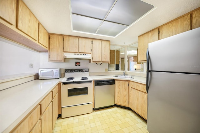 kitchen featuring light brown cabinets, stainless steel appliances, sink, and light tile floors