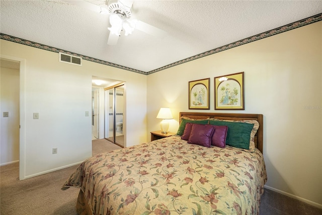 bedroom featuring a closet, a textured ceiling, ceiling fan, and light colored carpet