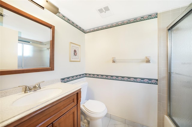 bathroom featuring vanity, tile floors, and toilet