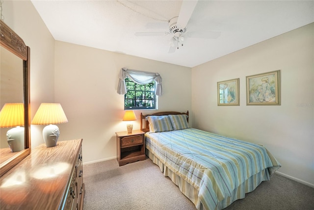 bedroom with ceiling fan and dark carpet