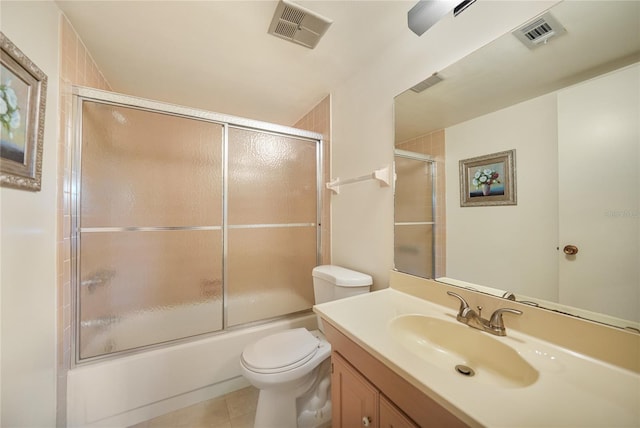 full bathroom featuring vanity, shower / bath combination with glass door, tile flooring, and toilet