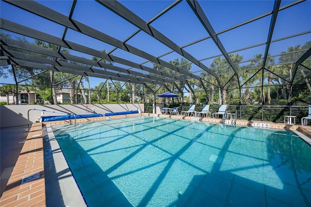 view of pool featuring glass enclosure