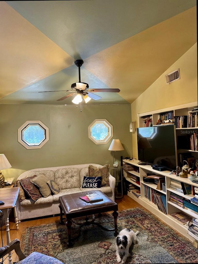 living room with lofted ceiling, plenty of natural light, ceiling fan, and hardwood / wood-style floors