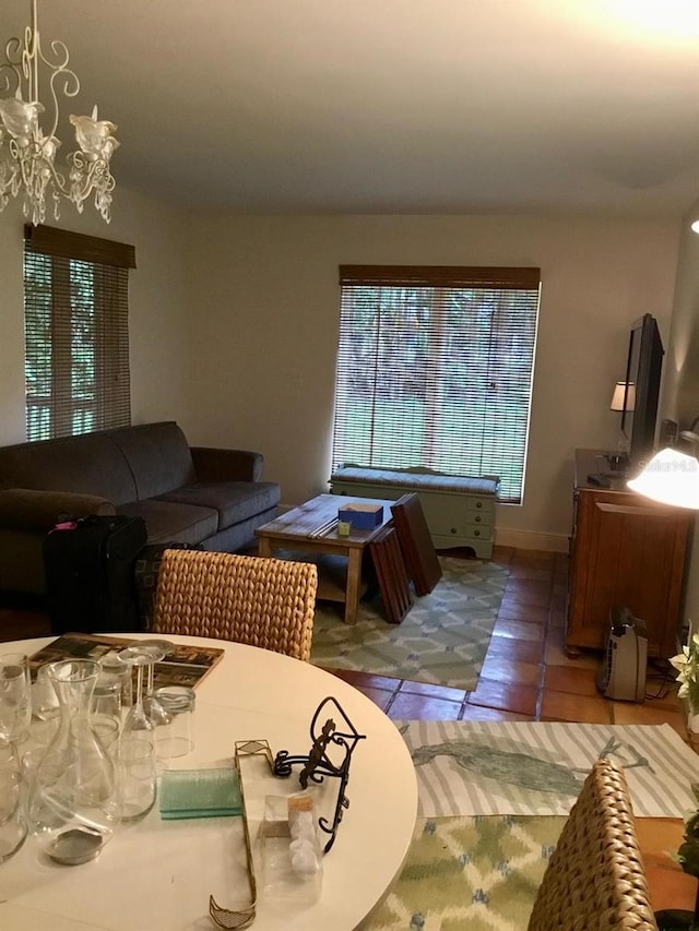 living room with a chandelier and tile patterned floors