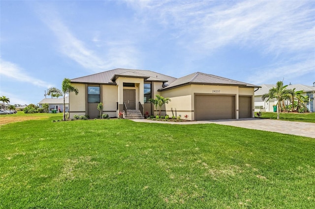 view of front of home with a garage and a front lawn