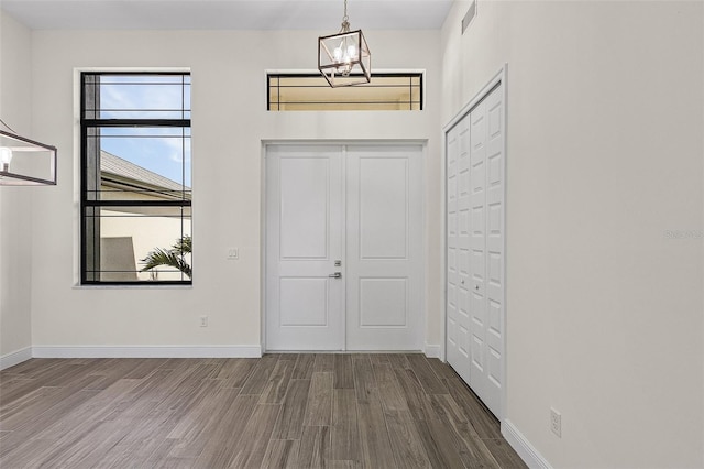 entrance foyer featuring hardwood / wood-style flooring and a notable chandelier