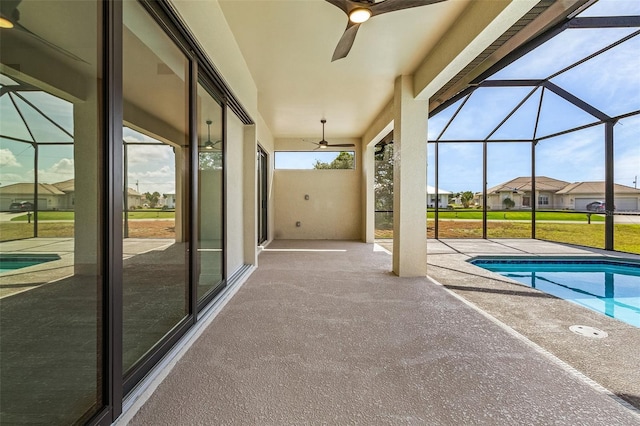 unfurnished sunroom with plenty of natural light and ceiling fan