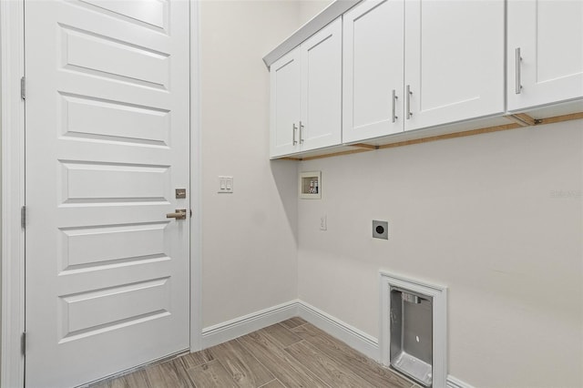 laundry area with cabinets, light hardwood / wood-style floors, washer hookup, and electric dryer hookup