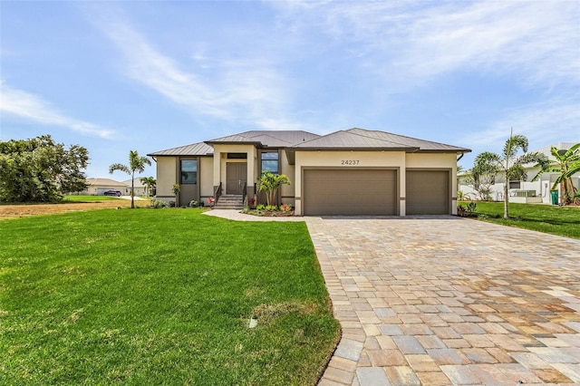 view of front of property with a garage and a front yard