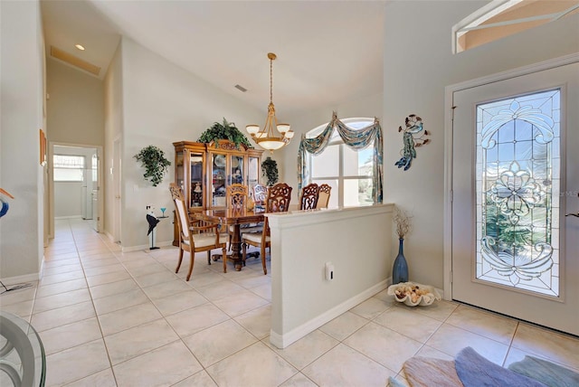 entrance foyer with a chandelier, light tile patterned floors, and lofted ceiling