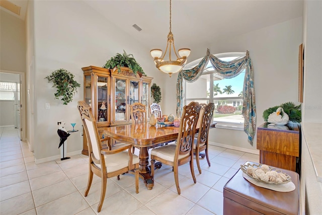 tiled dining room with a notable chandelier