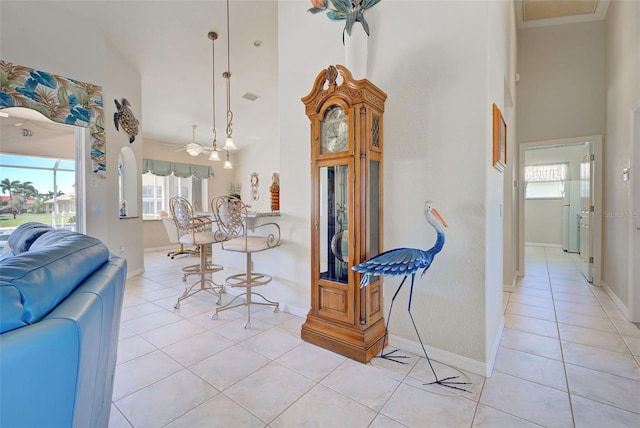 tiled dining room featuring a high ceiling