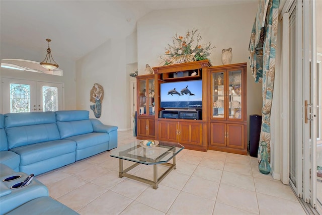 tiled living room with french doors and lofted ceiling