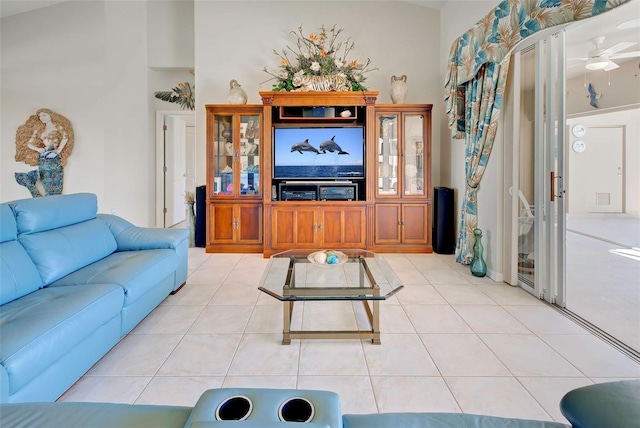 tiled living room with ceiling fan and lofted ceiling